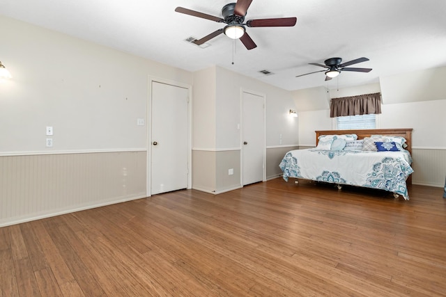 unfurnished bedroom featuring hardwood / wood-style floors and ceiling fan