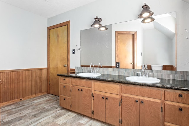 bathroom with wood-type flooring, tasteful backsplash, a textured ceiling, vanity, and lofted ceiling