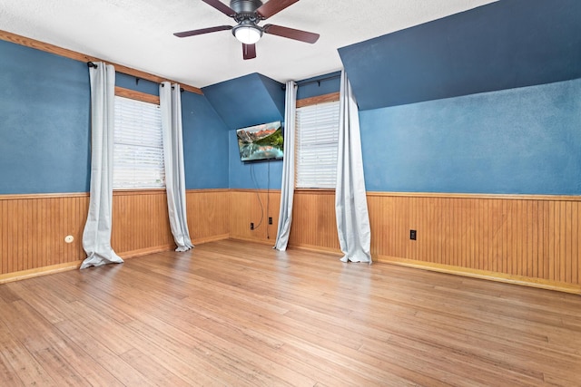 interior space featuring light wood-type flooring, a textured ceiling, and ceiling fan