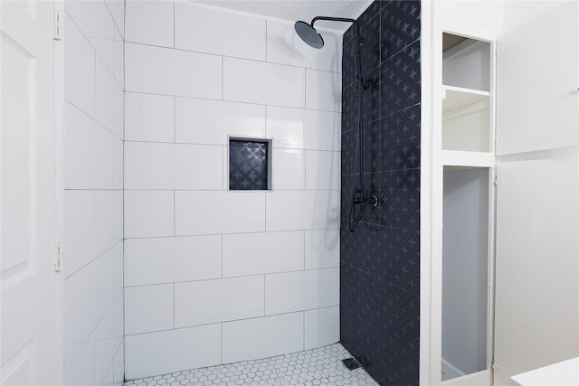 bathroom with tiled shower