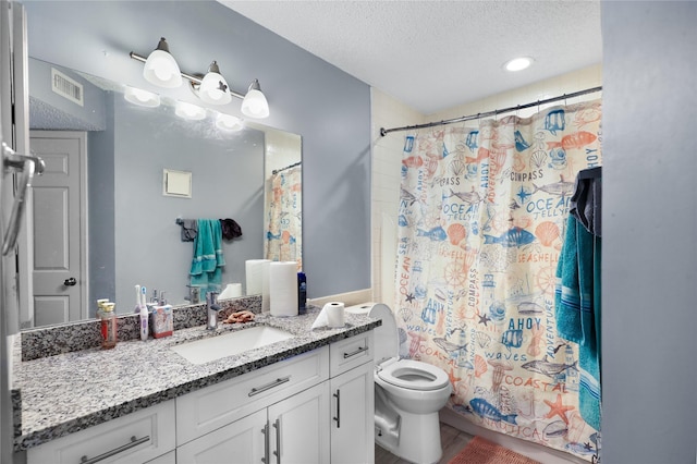 bathroom featuring a textured ceiling, toilet, and vanity