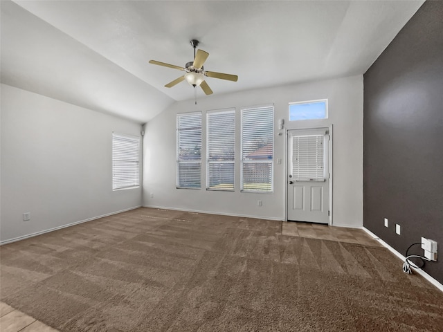 carpeted spare room featuring ceiling fan and lofted ceiling