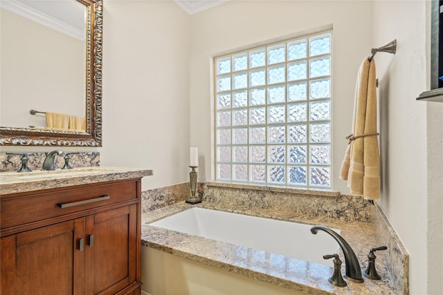 bathroom with vanity, crown molding, and a bath