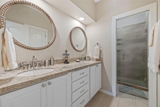 bathroom with vanity, a shower with shower door, and tile patterned floors