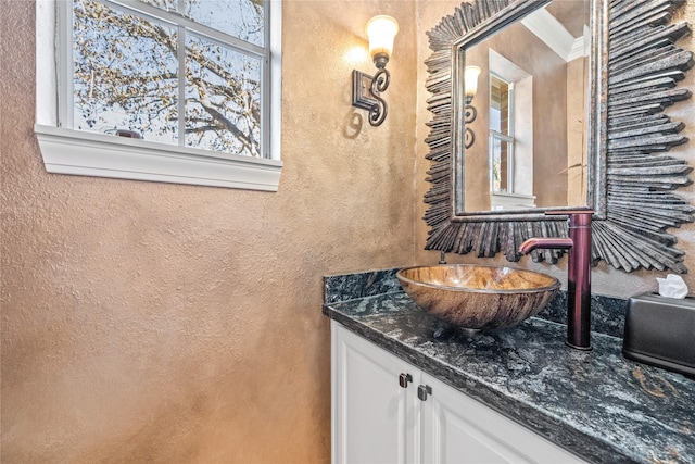 bathroom with ornamental molding and vanity