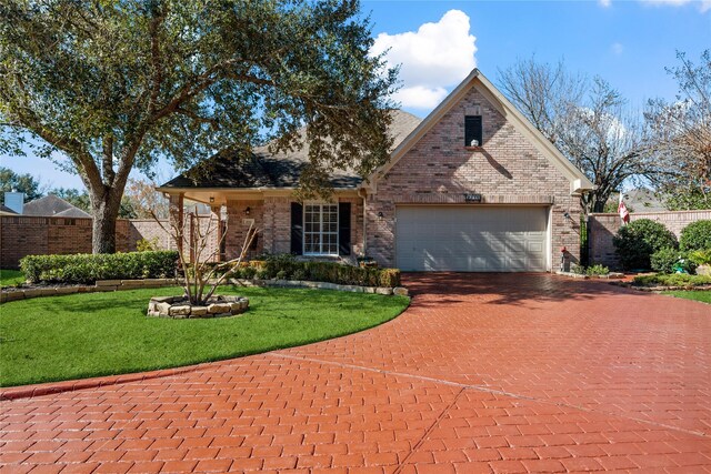 view of front of property featuring a front yard and a garage