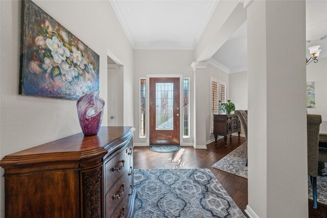 entryway featuring ornate columns, dark hardwood / wood-style floors, and ornamental molding