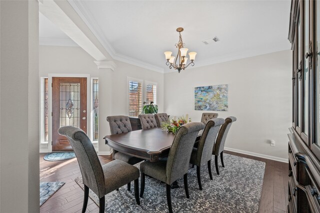 dining area with a chandelier, crown molding, and dark hardwood / wood-style flooring