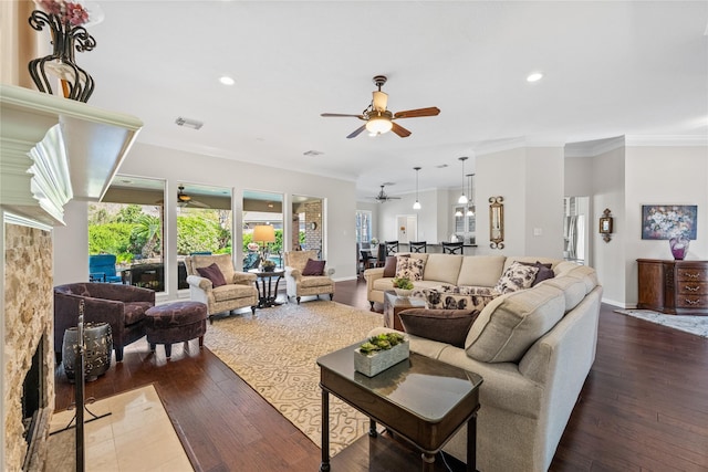 living room with ceiling fan, ornamental molding, and dark hardwood / wood-style floors