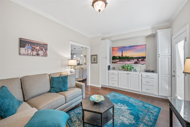 living room with dark wood-type flooring and ornamental molding