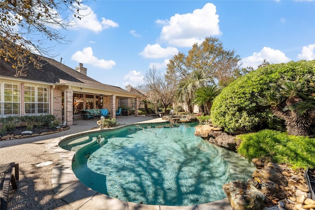 view of pool featuring a patio