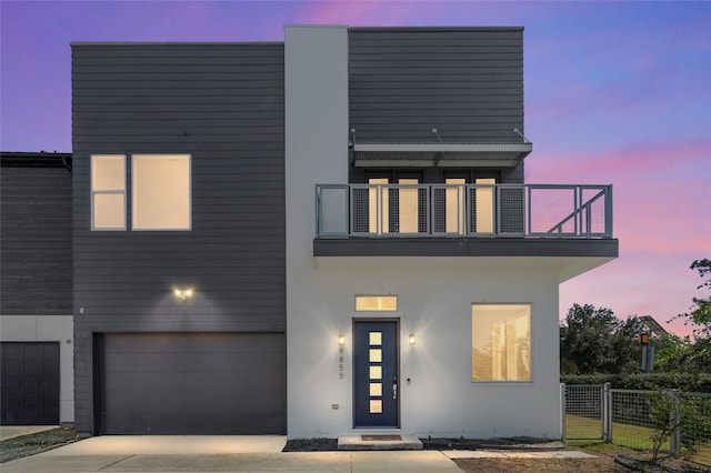 modern home with a garage and a balcony