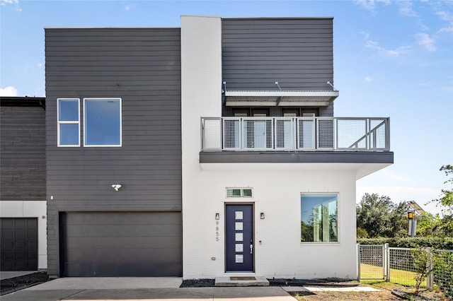 contemporary house with a balcony and a garage