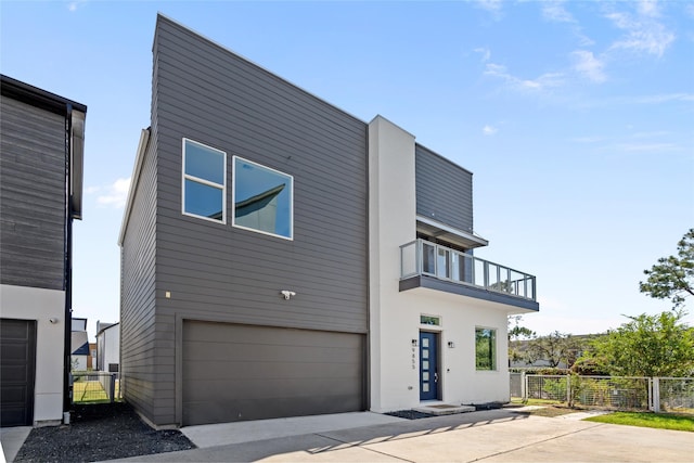 view of home's exterior with a balcony and a garage