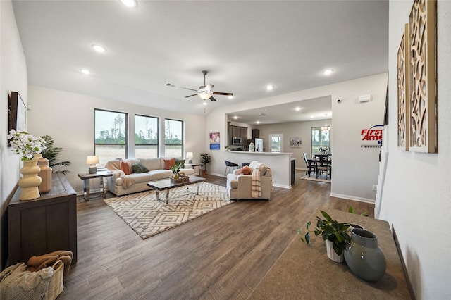 living room with ceiling fan, dark wood-type flooring, and plenty of natural light