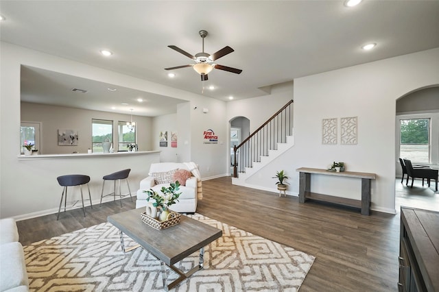 living room with ceiling fan and dark hardwood / wood-style floors