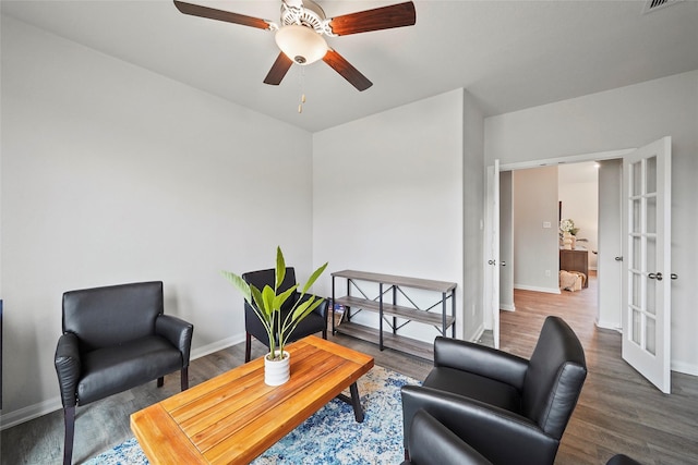 sitting room featuring ceiling fan, french doors, and dark hardwood / wood-style floors