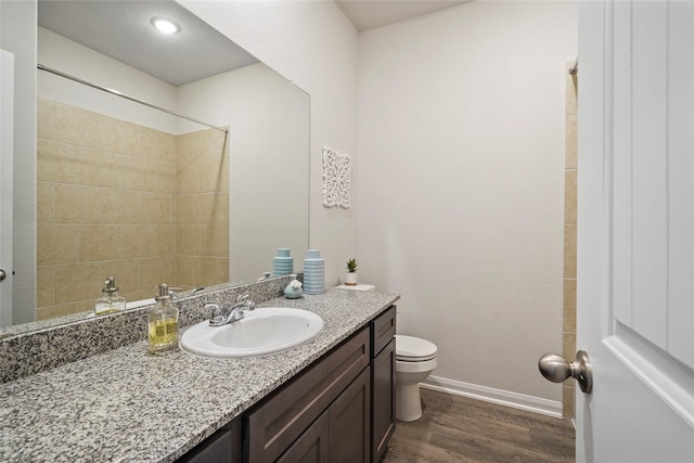 bathroom featuring vanity, toilet, and hardwood / wood-style floors