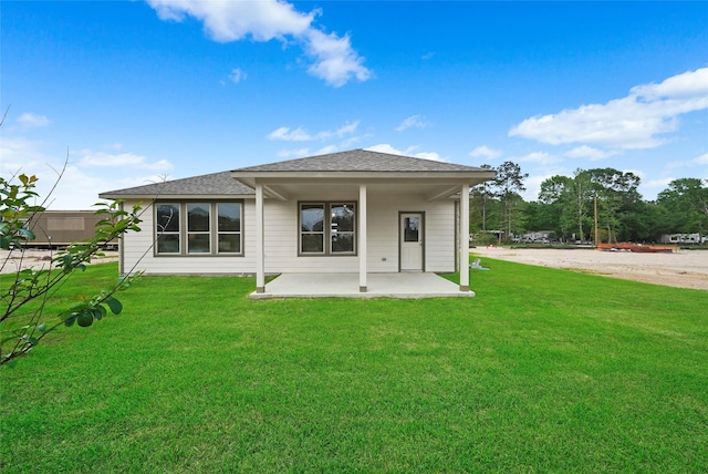 back of house featuring a yard and a patio