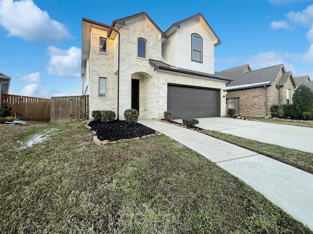 view of front of house featuring a garage and a front lawn