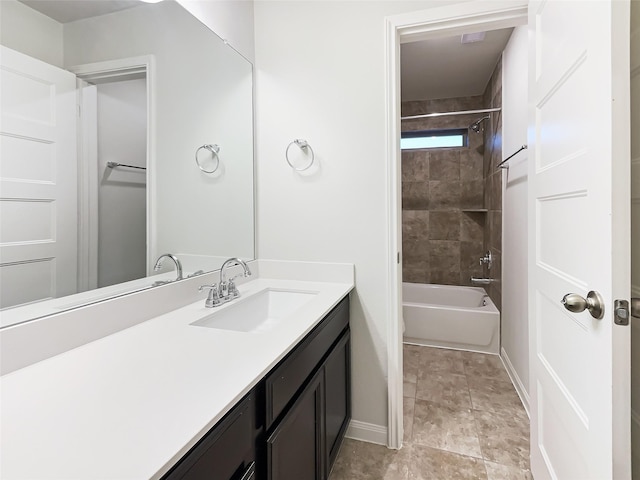 bathroom featuring vanity and tiled shower / bath