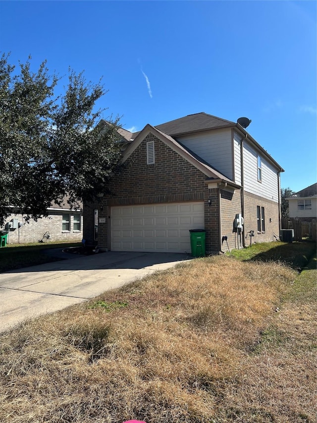 view of home's exterior featuring a garage and cooling unit