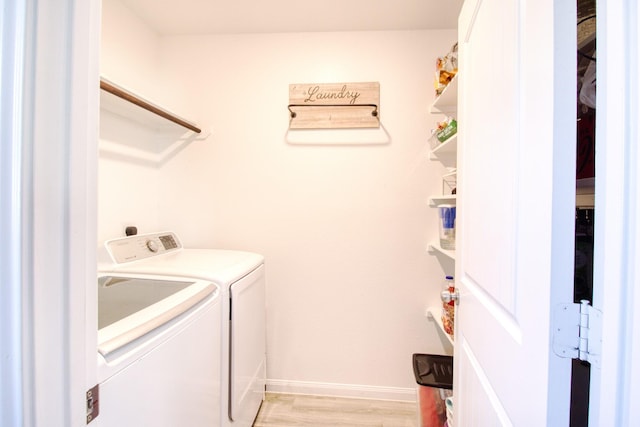 washroom with independent washer and dryer and light wood-type flooring