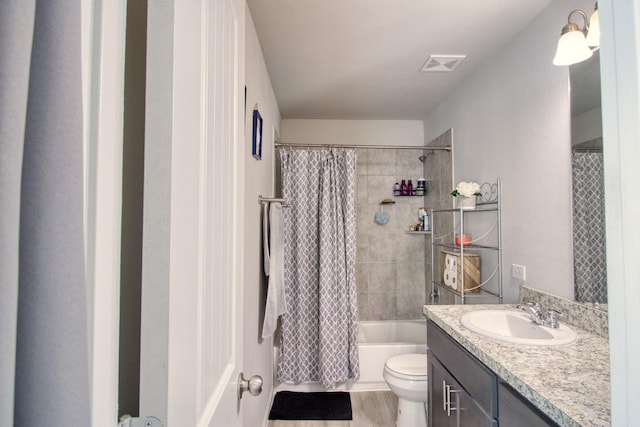 full bathroom featuring hardwood / wood-style floors, toilet, vanity, and shower / tub combo with curtain