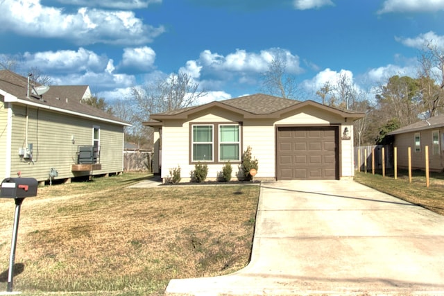 view of front of home with a garage and a front lawn