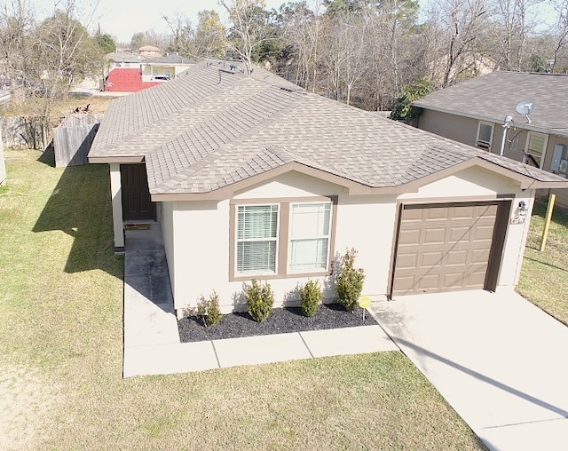 view of front of property featuring a garage and a front yard