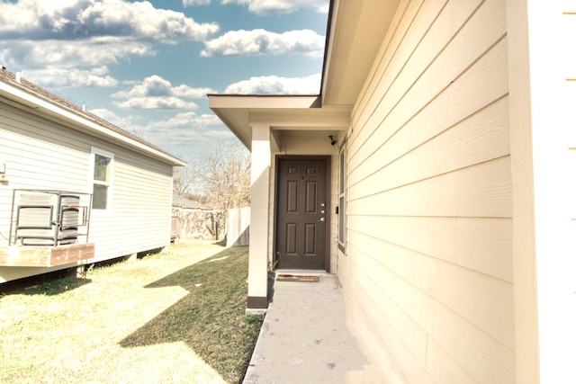 property entrance with a yard