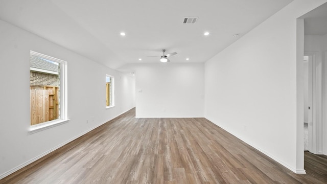 spare room featuring hardwood / wood-style flooring, ceiling fan, and vaulted ceiling