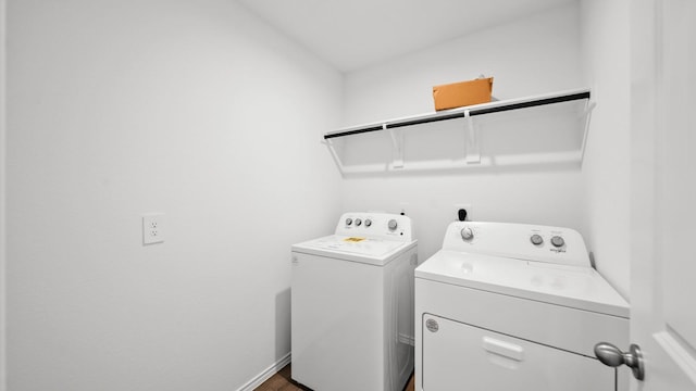 clothes washing area with washer and clothes dryer