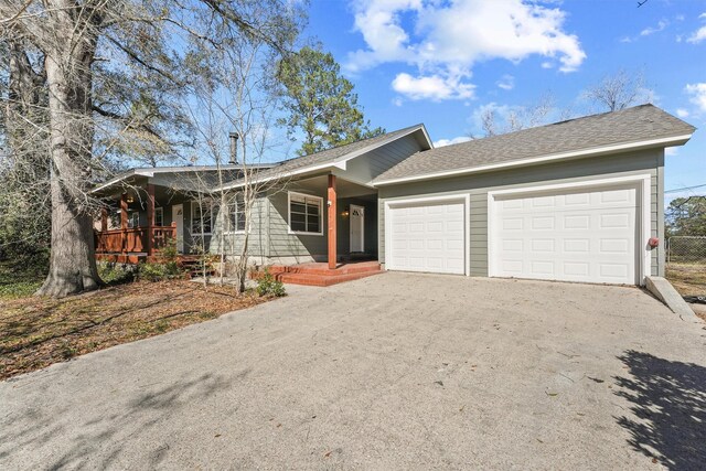 ranch-style home with a garage and covered porch