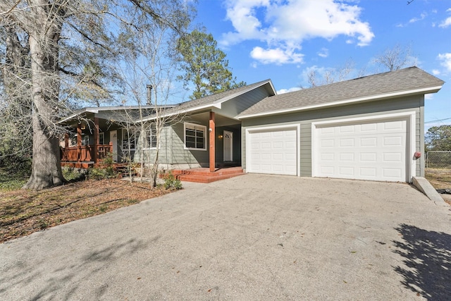 single story home featuring an attached garage, driveway, and roof with shingles