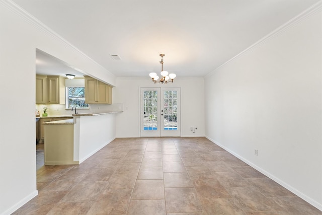 unfurnished living room featuring ornamental molding, a sink, baseboards, and an inviting chandelier