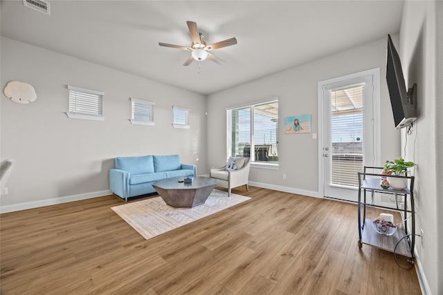 living area featuring ceiling fan and light wood-type flooring