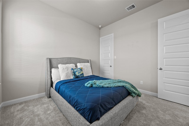 bedroom with light colored carpet