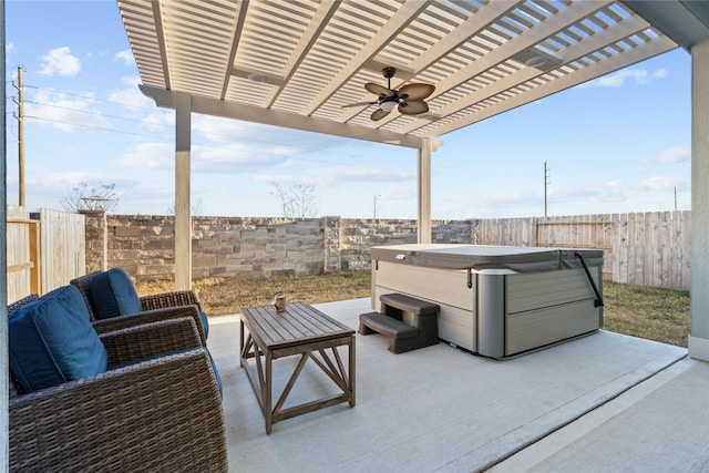 view of patio featuring a hot tub, ceiling fan, and a pergola