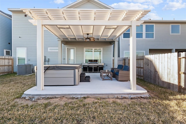 back of house featuring cooling unit, a yard, a pergola, a hot tub, and an outdoor hangout area