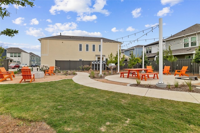 back of property with a yard and a patio