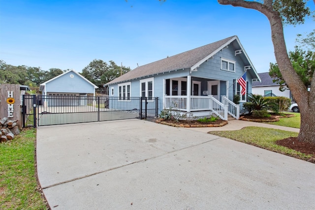 bungalow-style house featuring a porch, a garage, and a front yard