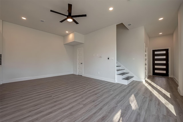 unfurnished living room with hardwood / wood-style flooring and ceiling fan