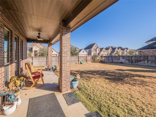 view of yard with ceiling fan and a patio area