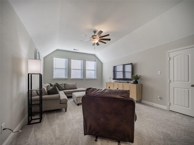 carpeted living room featuring ceiling fan and lofted ceiling