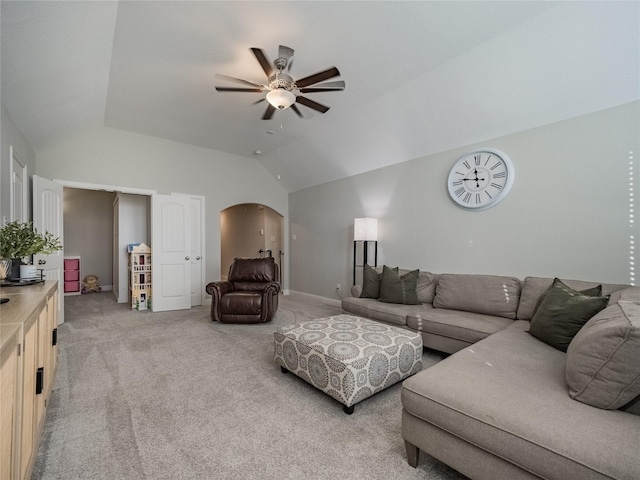 living room with ceiling fan, vaulted ceiling, and light carpet