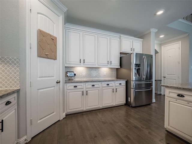 kitchen with tasteful backsplash, stainless steel fridge with ice dispenser, and white cabinets