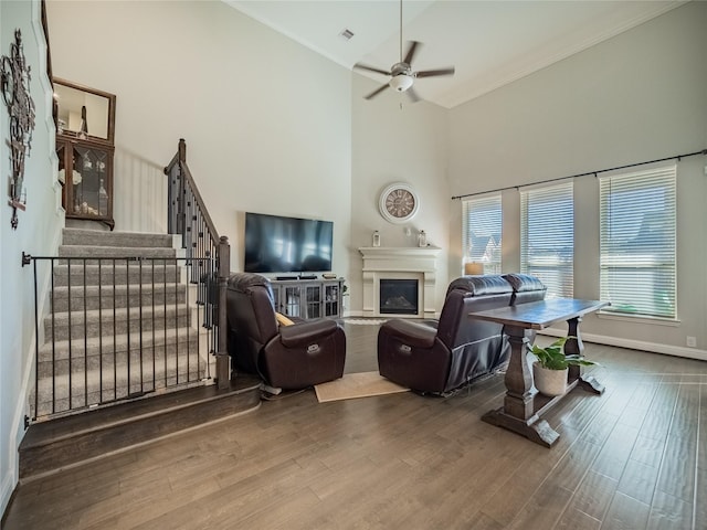 living room featuring ceiling fan, wood-type flooring, and high vaulted ceiling