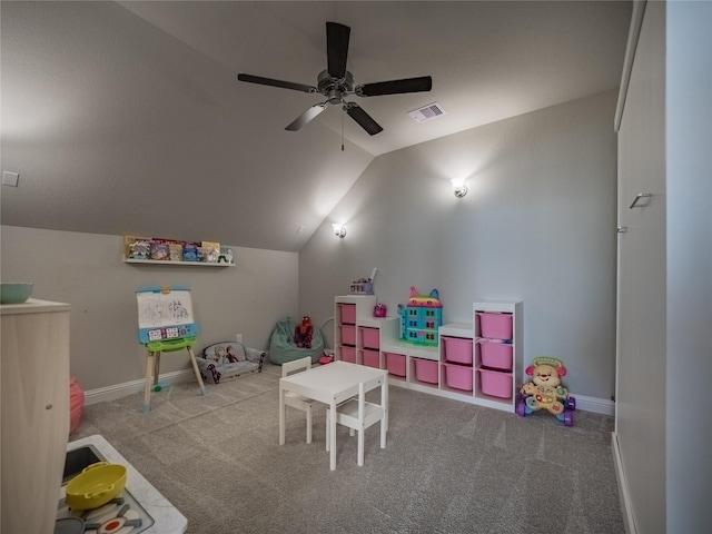 recreation room featuring vaulted ceiling, light colored carpet, and ceiling fan