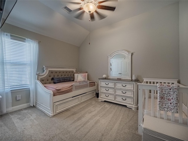 bedroom featuring lofted ceiling, light carpet, and ceiling fan